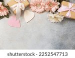 Valentine's Day background with gifts, beautiful flowers and hearts. Valentine's day, Womans day, wedding, birthday or mothers day greeting card. View from above. Copy space.