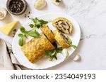 Small photo of Vegetarian delicious food. Zucchini roll (roulade) with cheese and mushrooms on a marble tabletop. View from above. Copy space.