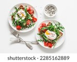 Small photo of Wholegrain bread sandwiches with avocado, poached egg and arugula cherry tomatoes salad - delicious healthy breakfast, brunch on a light background, top view
