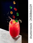 Small photo of Sweet and fresh gummy bear cocktail with some gummy bears falling making a splash of flavor