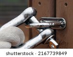 Small photo of Shining stainless straght shackle with mooring rope tide up on the wood deck. Close up macro photography.