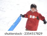 boy playing on a sled
