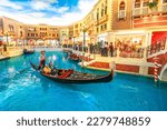 Small photo of Macau, China - December 9, 2016: A gondolier is taking tourists on a romantic ride through the canals of the Venetian Luxury Hotel and Casino and mall in Macau.