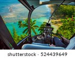 Helicopter cockpit flies in Kee Beach, Kauai, Hawaii, United States, with pilot arm and control board inside the cabin.