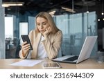 Sad and disappointed woman received bad news online, business woman at workplace inside office in depression reading bad news using app on smartphone, female worker with phone in hands thoughtful.