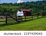 Small photo of Photo of a red roofed barn with a fence in the Virgina countryside.