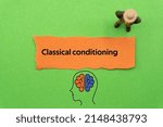 Small photo of Classical conditioning.The word is written on a slip of colored paper. Psychological terms, psychologic words, Spiritual terminology. psychiatric research. Mental Health Buzzwords.