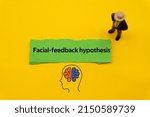 Small photo of Facial feedback hypothesis.The word is written on a slip of colored paper. Psychological terms, psychologic words, Spiritual terminology. psychiatric research. Mental Health Buzzwords.