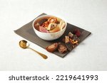 Small photo of Morel Cordyceps Flower Abalone Stewed Chicken Soup served in a dish isolated on napkin side view of hong kong food