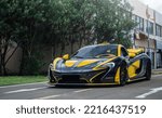 Small photo of Zhuhai, China- October 8,2022: A black and yellow McLaren P1 hypercar is parked on road