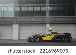 Small photo of Zhuhai, China- October 8,2022: A black and yellow McLaren P1 hypercar is parked on road