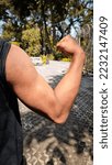 Small photo of man showing big and dashing muscles outdoor. muscular and sinewy hand.
