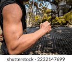 Small photo of Man showing big and dashing muscles outdoor. muscular and sinewy hand. SSTKsports.