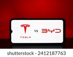 Small photo of Selective focus of the BYD vs Tesla Logo on a mobile screen stock image. These companies are two electric vehicle makers giant in the world: Dhaka, Bangladesh- Jan 7, 2024
