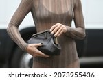 Small photo of Milan, Italy - September 22, 2021: Street style outfit, fashionable woman wearing Fendi on the streets of Milan, Italy.