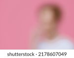 Small photo of strongly blurred beyond recognition portrait of a man in light clothes