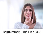 Small photo of Beautiful smiling Turkish woman is holding an invisalign bracer, includes copy space