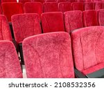 Empty Red cinema seats or theater seats lined up side by side, perspective photo

