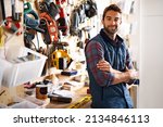 Lets fix it. Portrait of a handsome young handyman standing in front of his work tools.