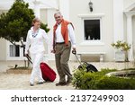 Small photo of Anticipating a well deserved holiday. Portrait of a senior couple arriving at their hotel with their suitcases in tow.
