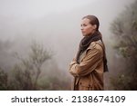 Small photo of Musings in the mist. An attractive young woman out for a walk in the mountains.