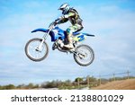 Small photo of Hes a crowd pleaser. A motocross rider in the air during a jump.