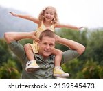 Small photo of Daughter may outgrow your arms, but she will never outgrow your heart. A young girl on her dads shoulders.
