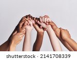 Small photo of Diversified as a whole. Shot of a group of hands holding on to each other against a white background.