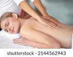 Small photo of Let all your tension melt away.... Shot of a young woman enjoying a massage at the spa.