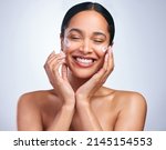 Small photo of The woman with the seemingly perfect life Be her. Shot of an attractive young woman applying moisturiser against a grey background.