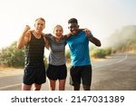 Small photo of Only those who persevere will become victorious. Portrait of a group of sporty young people celebrating after a workout outside.
