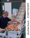 Small photo of Its an eggy business. Shot of a focused mature factory worker sorting out chicken eggs on a conveyer belt inside of a factory.
