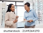 Small photo of Great eye care at affordable cost. Shot of a an optometrist helping a young woman choose a new pair of glasses.