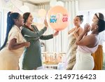 Small photo of Time to find out. Shot of a group of women about to pop a balloon for a gender reveal during a baby shower.