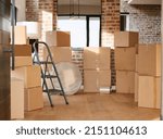 Small photo of A house without comfy chairs inside is soulless. Shot of boxes in a room at home.