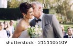 Small photo of Daddy is so proud of you. Cropped shot of an affectionate mature father kissing his daughter on the cheek on her wedding day.