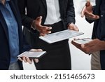 Small photo of Data processing minus the paper. Shot of a group of businesspeople using wireless devices during a meeting in a modern office.