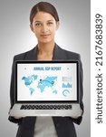 Small photo of The figures speak for themselves. Studio shot of a businesswoman holding a laptop showing a world map with financial data on it.