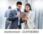 Small photo of You cant do everything so put your connections and resources to good use. Shot of two businesspeople discussing something on a digital tablet.