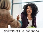 Handshake with a happy, confident and excited business woman or human resources manager and a female colleague, partner or employee. An agreement, deal or meeting with a coworker in the boardroom