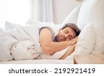 Small photo of Home, bedroom and sleeping man in the morning lying his head on the pillow in apartment space. Tired, fatigue and relax male taking time off on the weekend in bed of airbnb or hotel accommodation