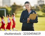 Small photo of Soccer field, woman coach with and girl team training on grass in background. Sports, youth development and teamwork, a happy young female volunteer coaching football team with clipboard from Brazil.