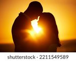 Silhouette, sunset and couple on honeymoon love bonding, hugging and enjoying quality time together in Los Angeles. Romantic woman and partner on holiday vacation in a dark night on Valentines day