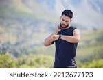 Man on run check pulse, heart rate and body stats for health with smartwatch on nature run. Runner does outdoor exercise for fitness, sports workout and cardio training to increase race running time