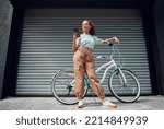 Small photo of Bicycle, phone and black woman in city, street or urban road outdoors. Bike, travel and happy female from South Africa on 5g mobile tech, internet browsing or social media, web or online surfing.