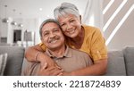 Small photo of Portrait of elderly love, grandparents smile on sofa and old couple relax at home in happy retirement. Senior man, grandmother on couch and smile in living room getting hug from retired wife on couch