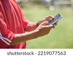Small photo of Strategy, tactics and coach with phone to educate, teach and inform soccer players to win a competitive football game. Modern sports coaching, digital tracking and match performance analytics