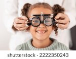 Eye, vision and test with child for glasses in optometry office for eye care and health. Eyewear, exam and medical opthalmology with little girl testing for lenses and frames diagnosis for optics
