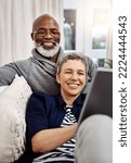 Small photo of Were having a wonderful weekend indoors. Shot of an affectionate senior couple using a tablet while relaxing on the sofa at home.