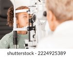 Small photo of Child, kid or girl in optometry eye exam with optometrist, ophthalmologist or consulting medical profession and clinic slit lamp. Eye test, children eye care or vision check for healthcare insurance